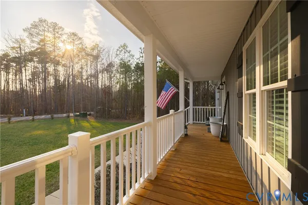 a view of a house with backyard and wooden deck