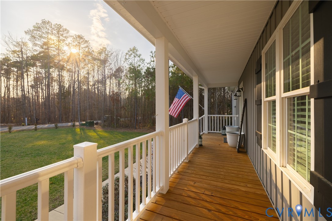 180 Barefords Mill Road Dunnsville, VA 22454 - Photo 24 of 27 a view of a house with backyard and wooden deck