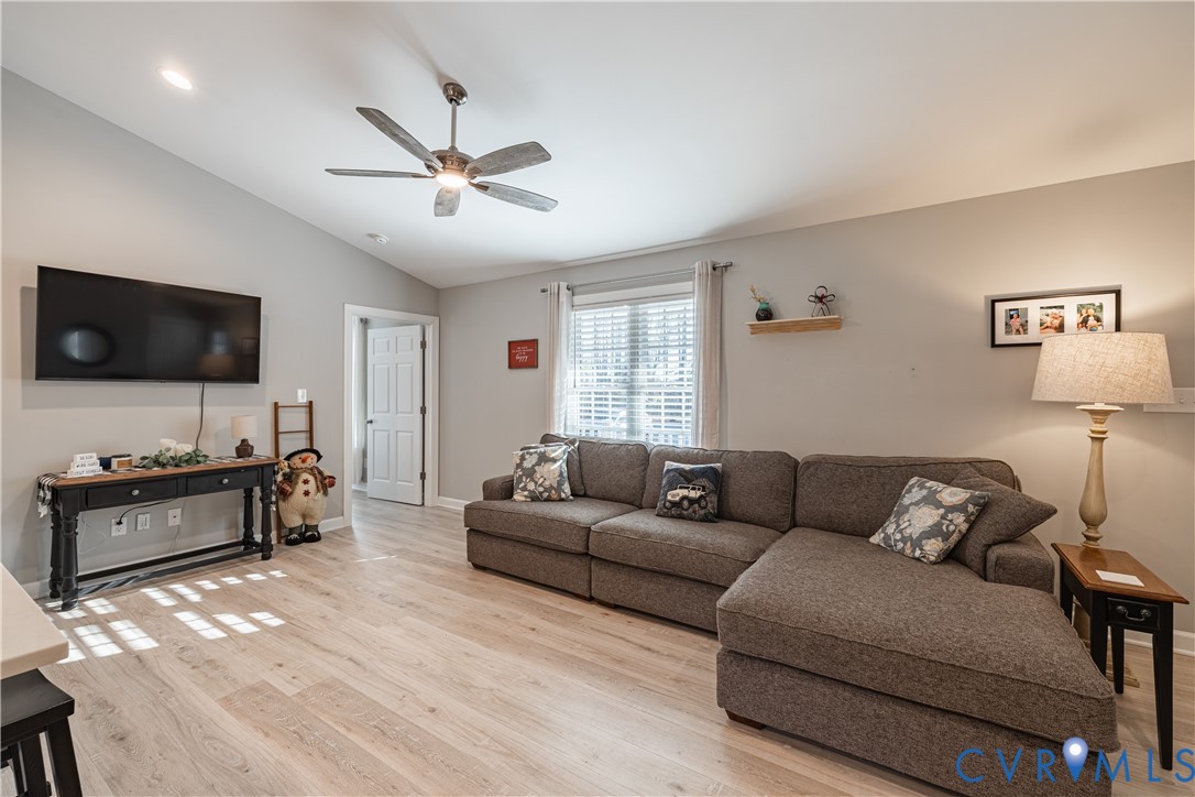 180 Barefords Mill Road Dunnsville, VA 22454 - Photo 8 of 27 a living room with furniture and a flat screen tv