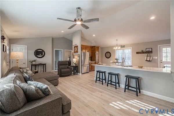 a living room with furniture and wooden floor