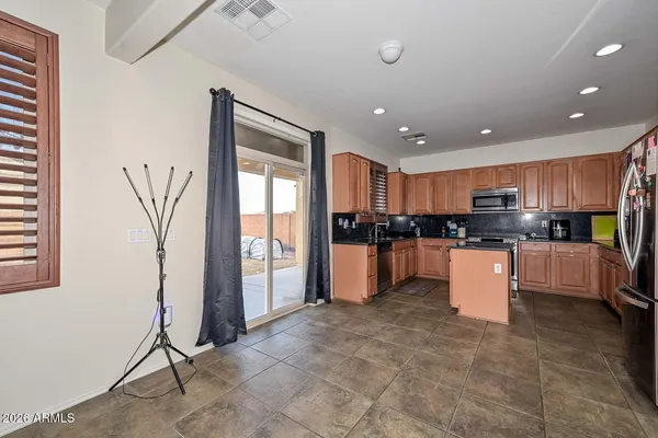 a kitchen with stainless steel appliances granite countertop a refrigerator and a sink