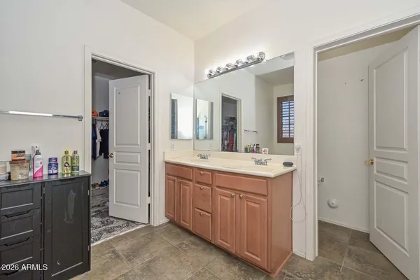 a bathroom with a sink vanity and a mirror