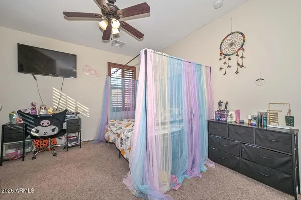 a living room with furniture a chandelier and a flat screen tv