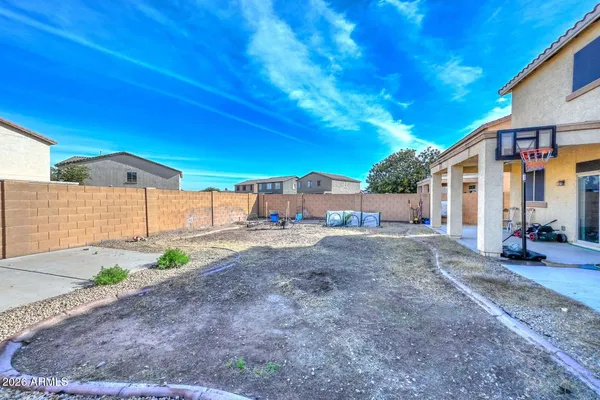 a view of a house with a yard and sitting area