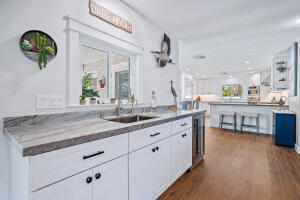 8766 Southeast Longview Drive Hobe Sound, FL 33455 - Photo 11 of 27 a bathroom with a granite countertop sink and a mirror