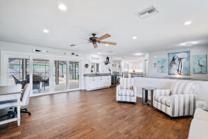 8766 Southeast Longview Drive Hobe Sound, FL 33455 - Photo 12 of 27 a living room with furniture and white walls