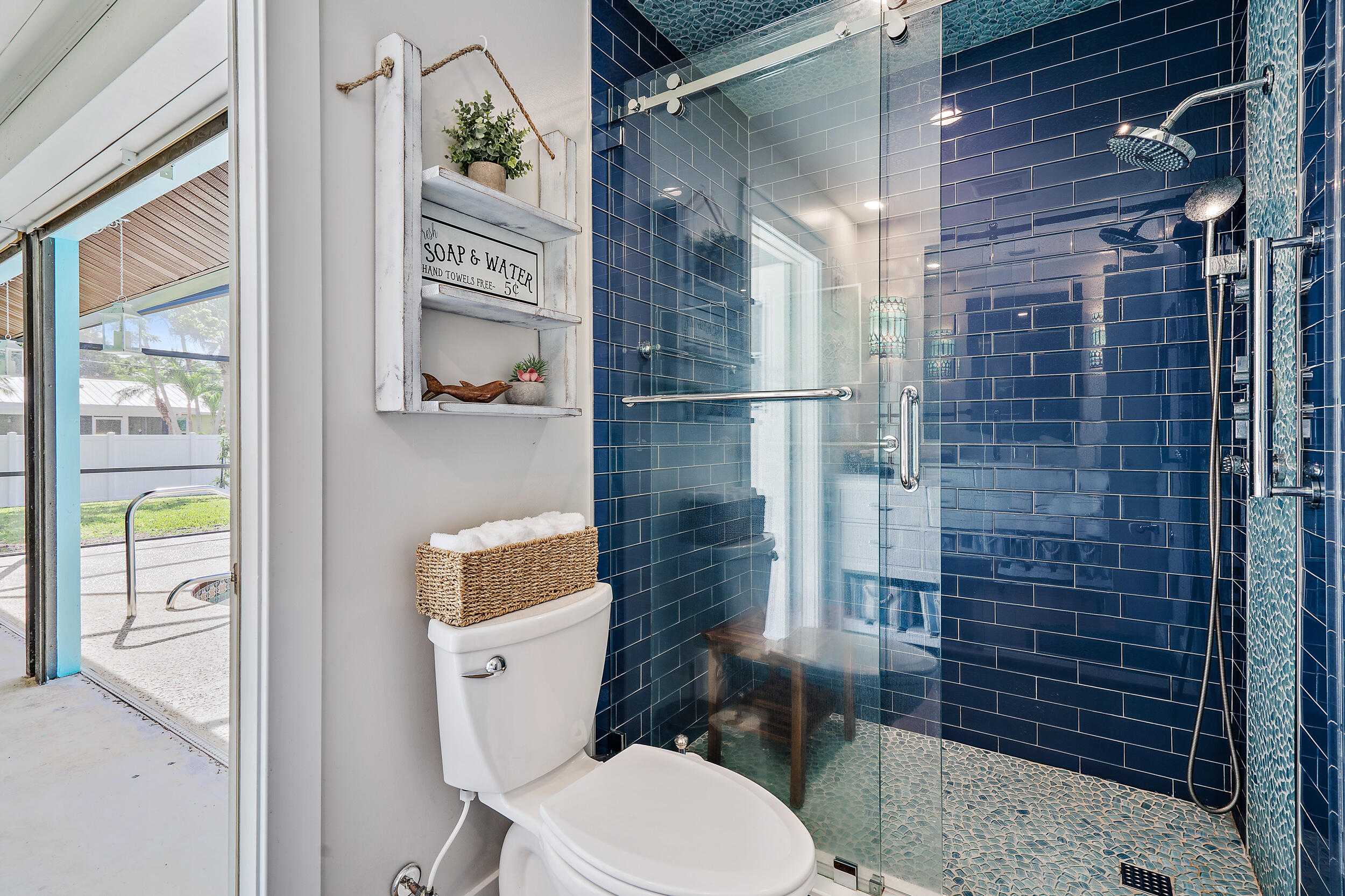 8766 Southeast Longview Drive Hobe Sound, FL 33455 - Photo 19 of 27 a bathroom with a toilet and a shower