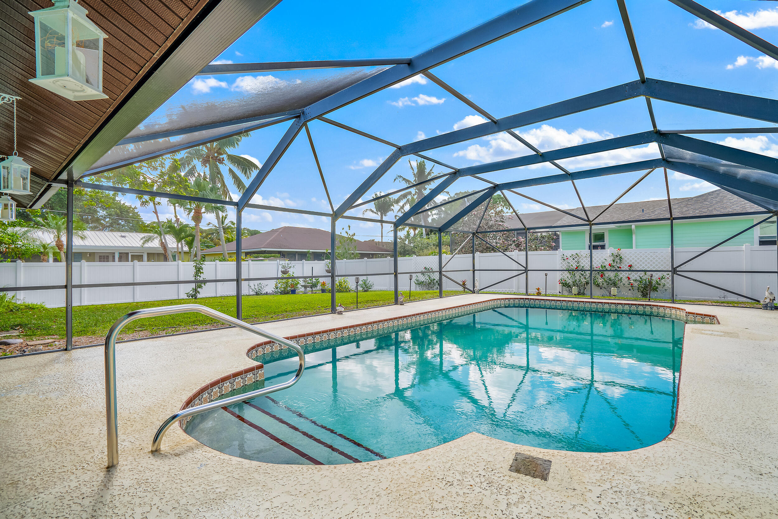 8766 Southeast Longview Drive Hobe Sound, FL 33455 - Photo 21 of 27 a swimming pool with an outdoor seating