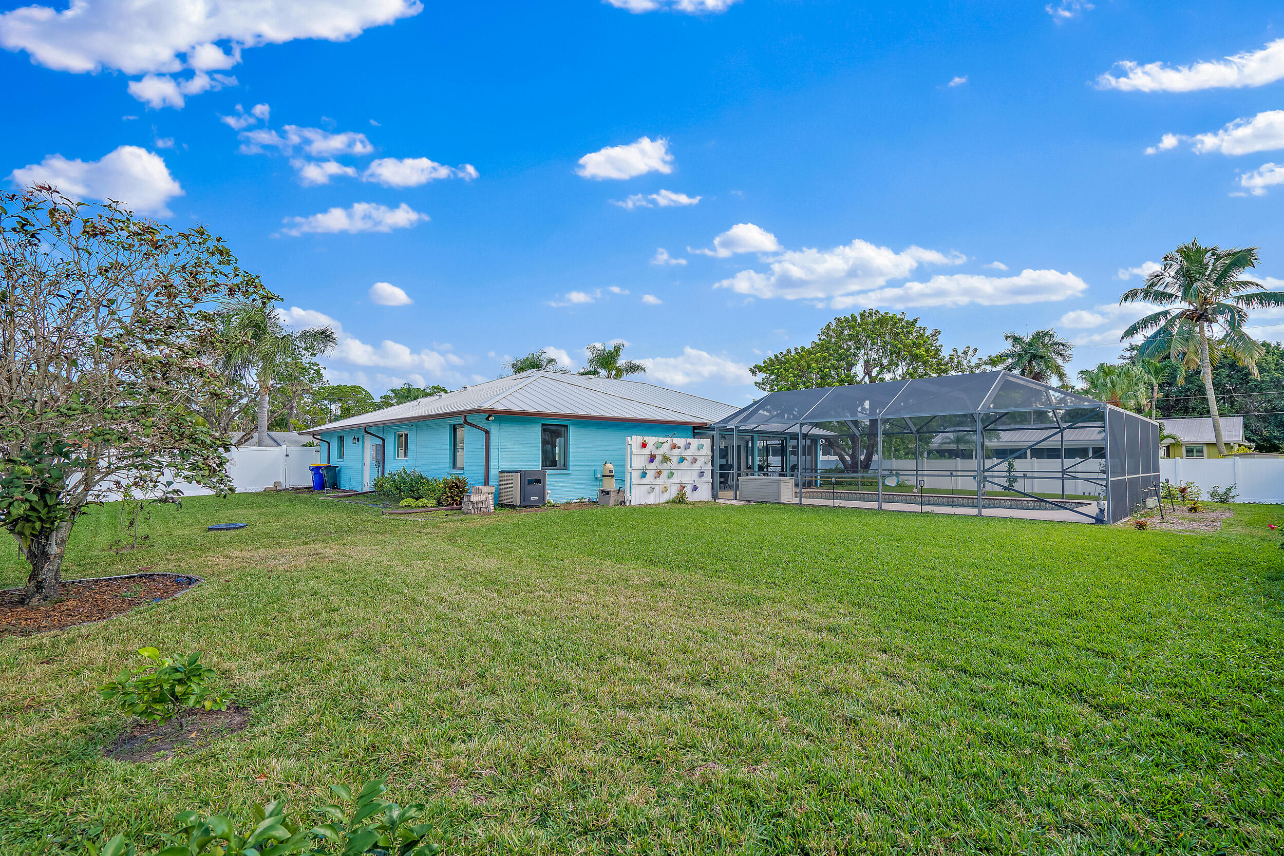 8766 Southeast Longview Drive Hobe Sound, FL 33455 - Photo 24 of 27 a view of a house with a big yard