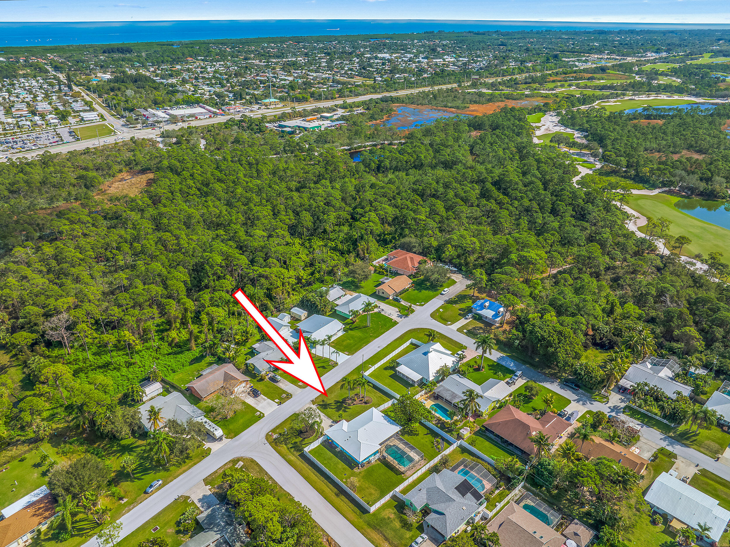 8766 Southeast Longview Drive Hobe Sound, FL 33455 - Photo 26 of 27 an aerial view of residential houses with outdoor space