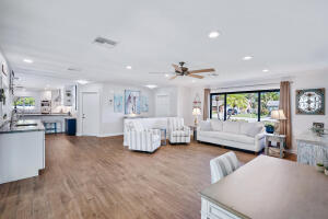 8766 Southeast Longview Drive Hobe Sound, FL 33455 - Photo 27 of 27 a living room with furniture and a large window