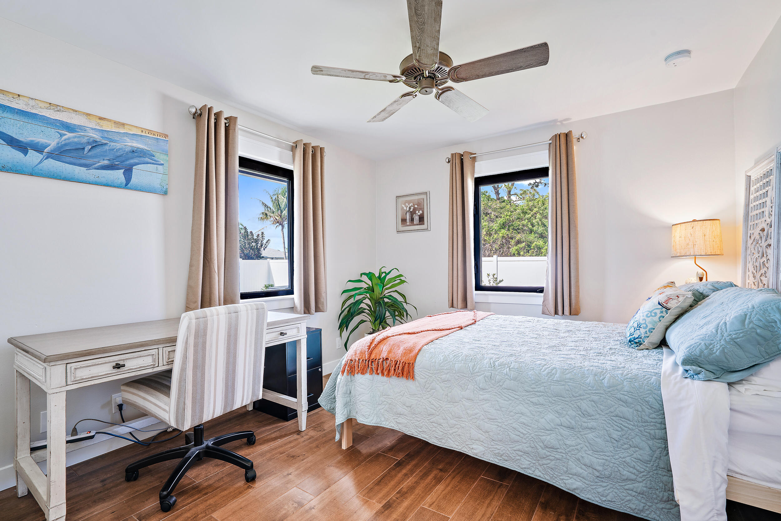 8766 Southeast Longview Drive Hobe Sound, FL 33455 - Photo 9 of 27 a bedroom with a bed potted plant with the wooden floor