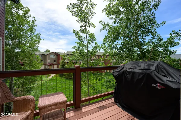 a view of balcony with wooden floor and outdoor seating