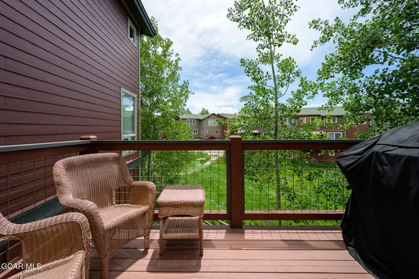 a view of balcony with wooden floor and outdoor seating