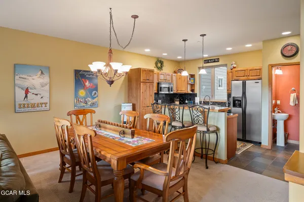 a view of a dining room with furniture and chandelier