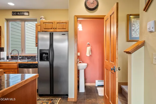 a kitchen with a refrigerator and a sink