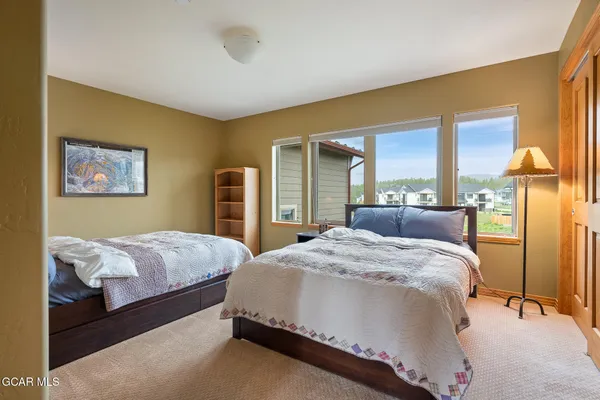 a spacious bedroom with a bed and window