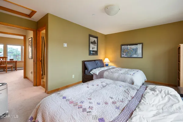 a bedroom with a large bed and a chandelier