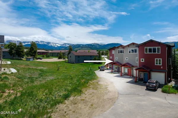 an aerial view of a house with a garden and yard