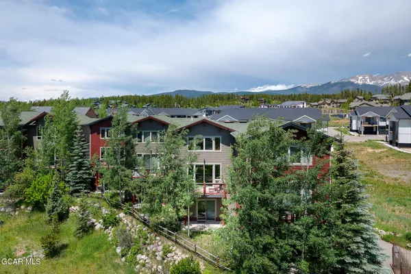 an aerial view of a house with a yard