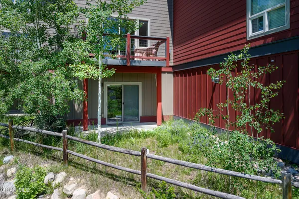 a view of a house with a window and flower plants