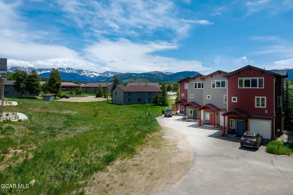 an aerial view of a house with a garden and yard