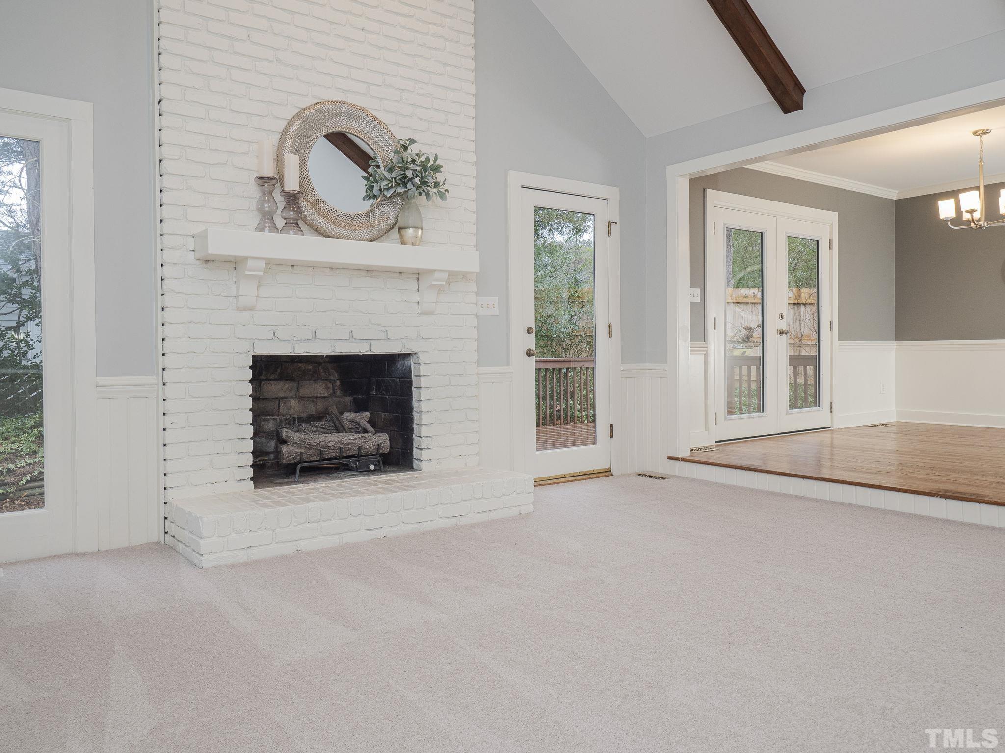 2301 Tamarack Court Raleigh, NC 27612 - Photo 8 of 33 an empty room with fireplace and windows