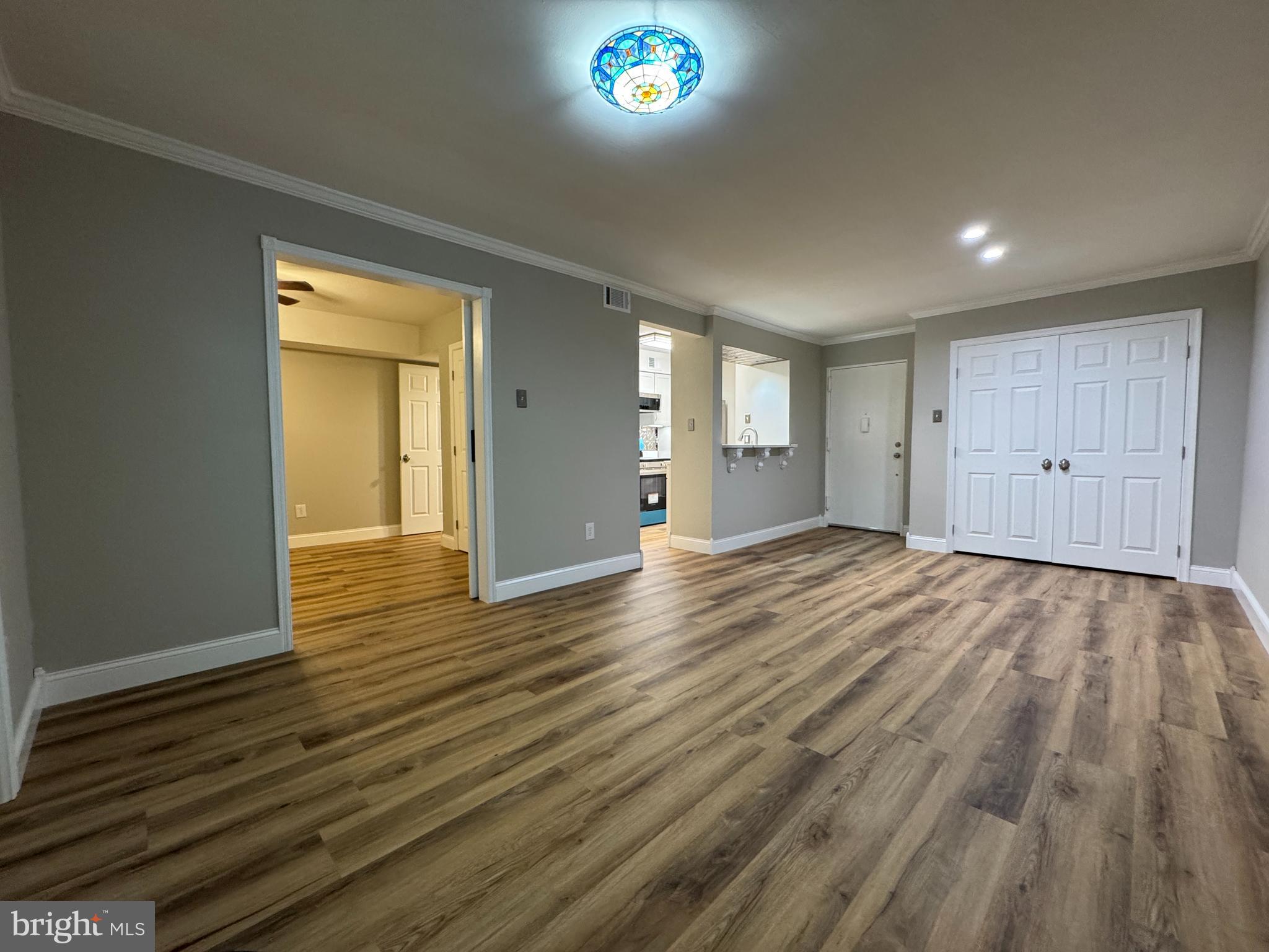 5812 Royal Ridge Drive, Unit C Springfield, VA 22152 - Photo 6 of 21 a view of an empty room with wooden floor and a window