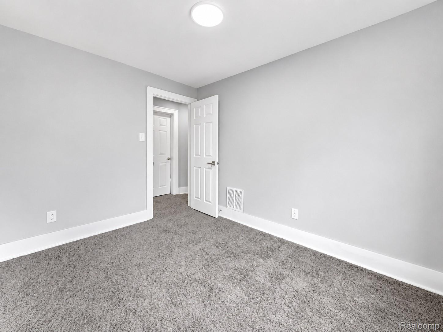 9175 Devonshire Road Detroit, MI 48224 - Photo 14 of 23 Neutral-toned interior room with gray carpet flooring and light gray painted walls