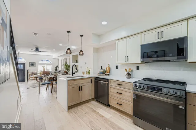 a kitchen with a sink stove and cabinets