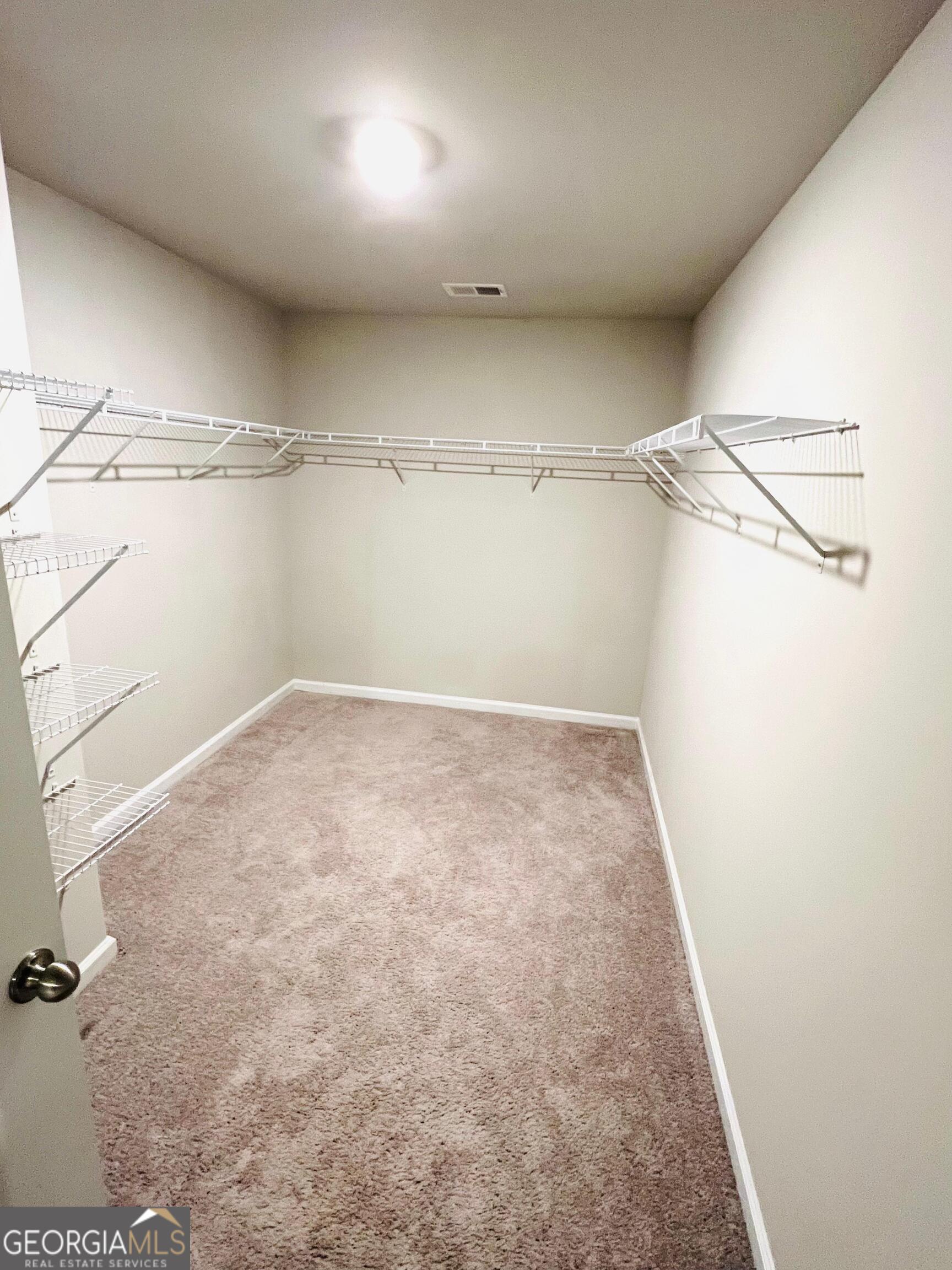 2206 Justify Lane Lithonia, GA 30058 - Photo 14 of 25 a view of a room with racks on the wall