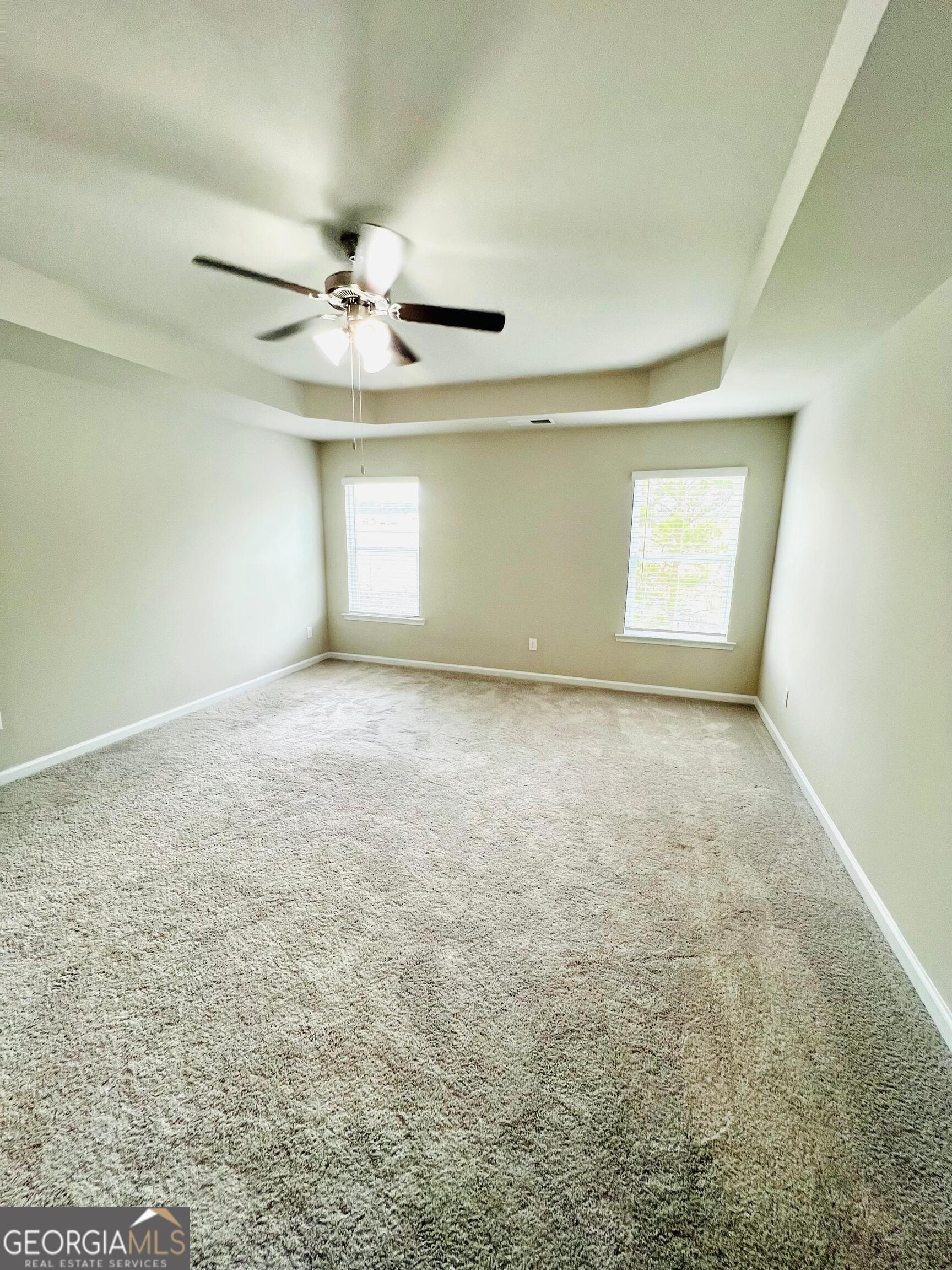 2206 Justify Lane Lithonia, GA 30058 - Photo 17 of 25 en empty room with windows and fan
