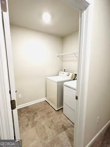 a bathroom with a shower and a glass door