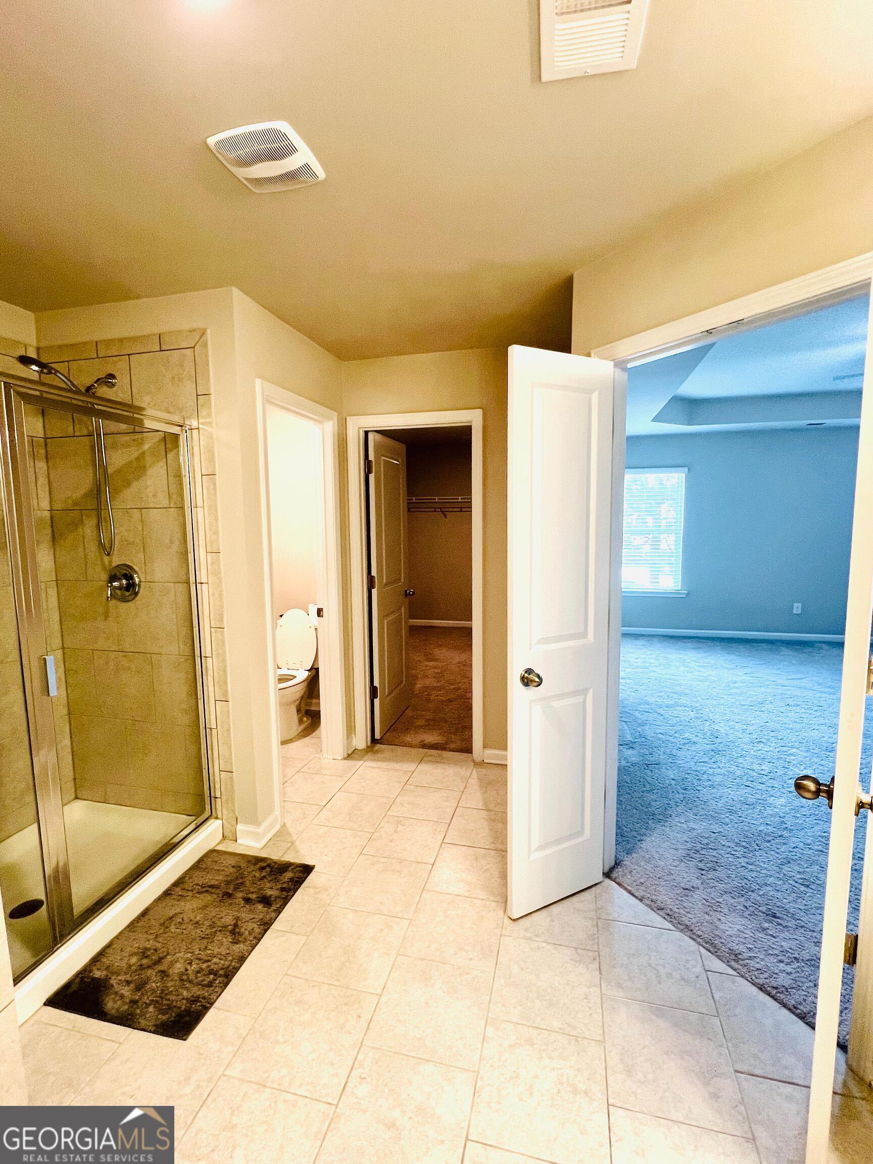 2206 Justify Lane Lithonia, GA 30058 - Photo 19 of 25 a bathroom with a shower and a glass door