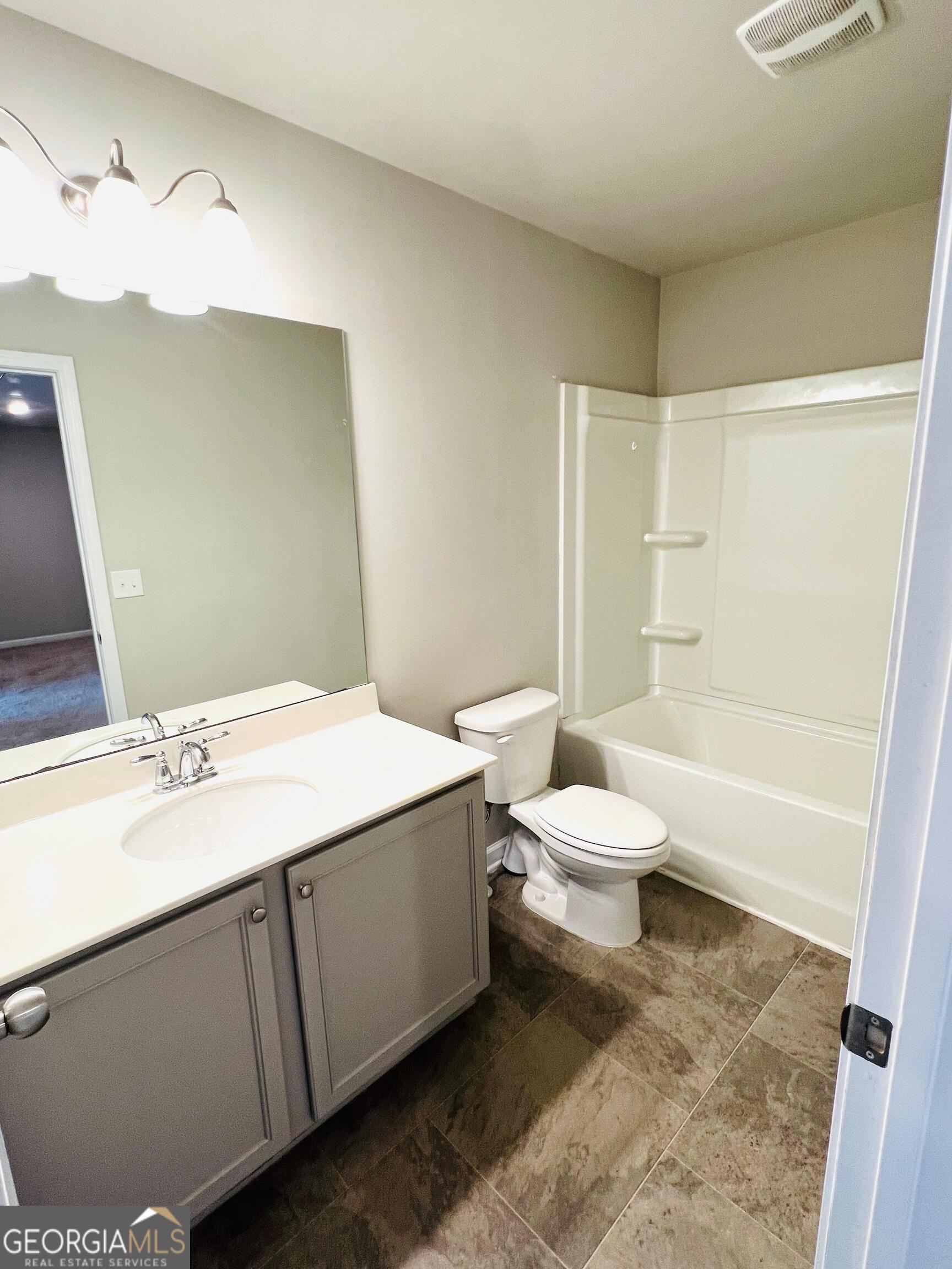 2206 Justify Lane Lithonia, GA 30058 - Photo 20 of 25 a bathroom with a sink a toilet and shower