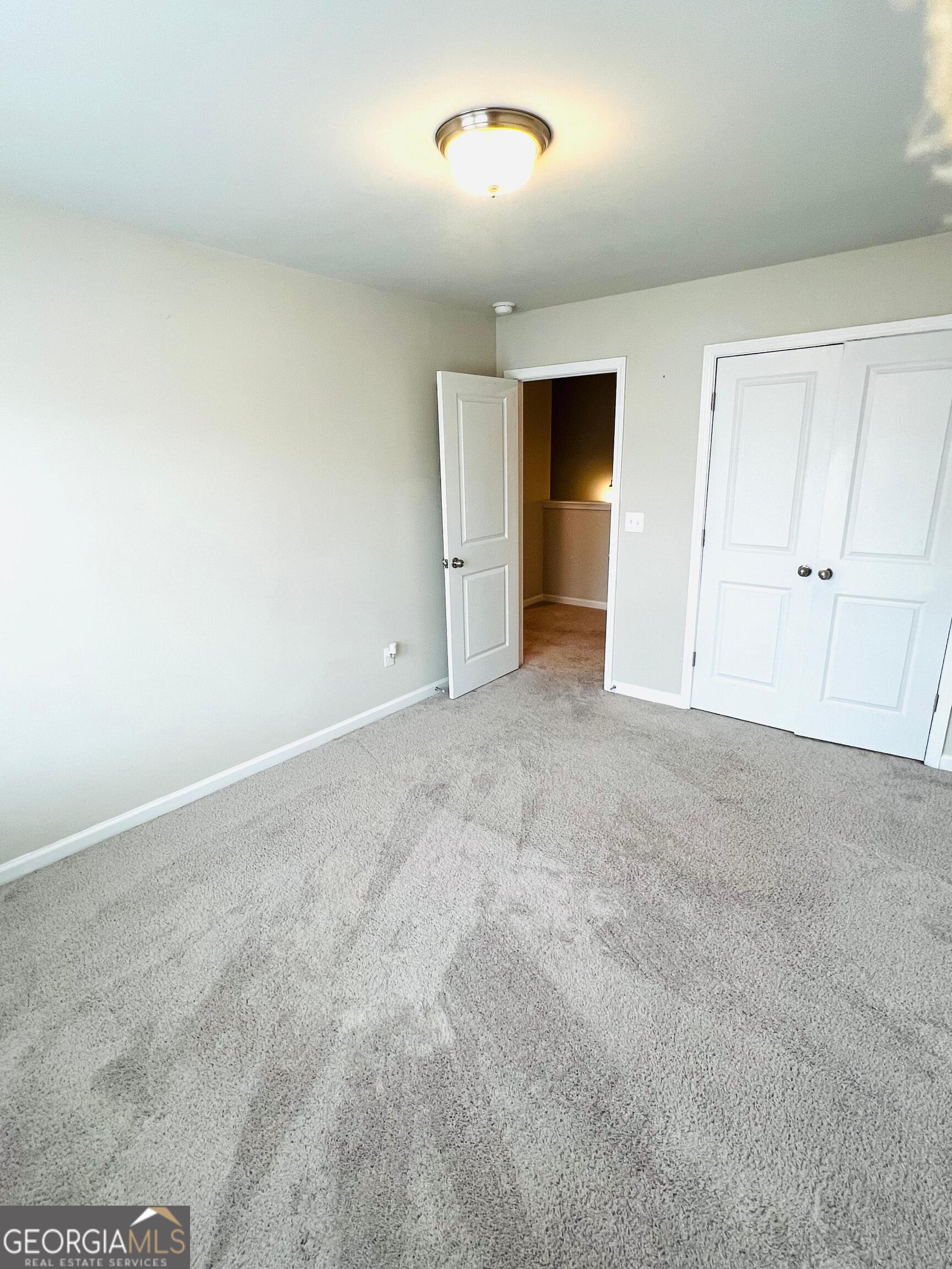 2206 Justify Lane Lithonia, GA 30058 - Photo 23 of 25 an empty room with closet and windows
