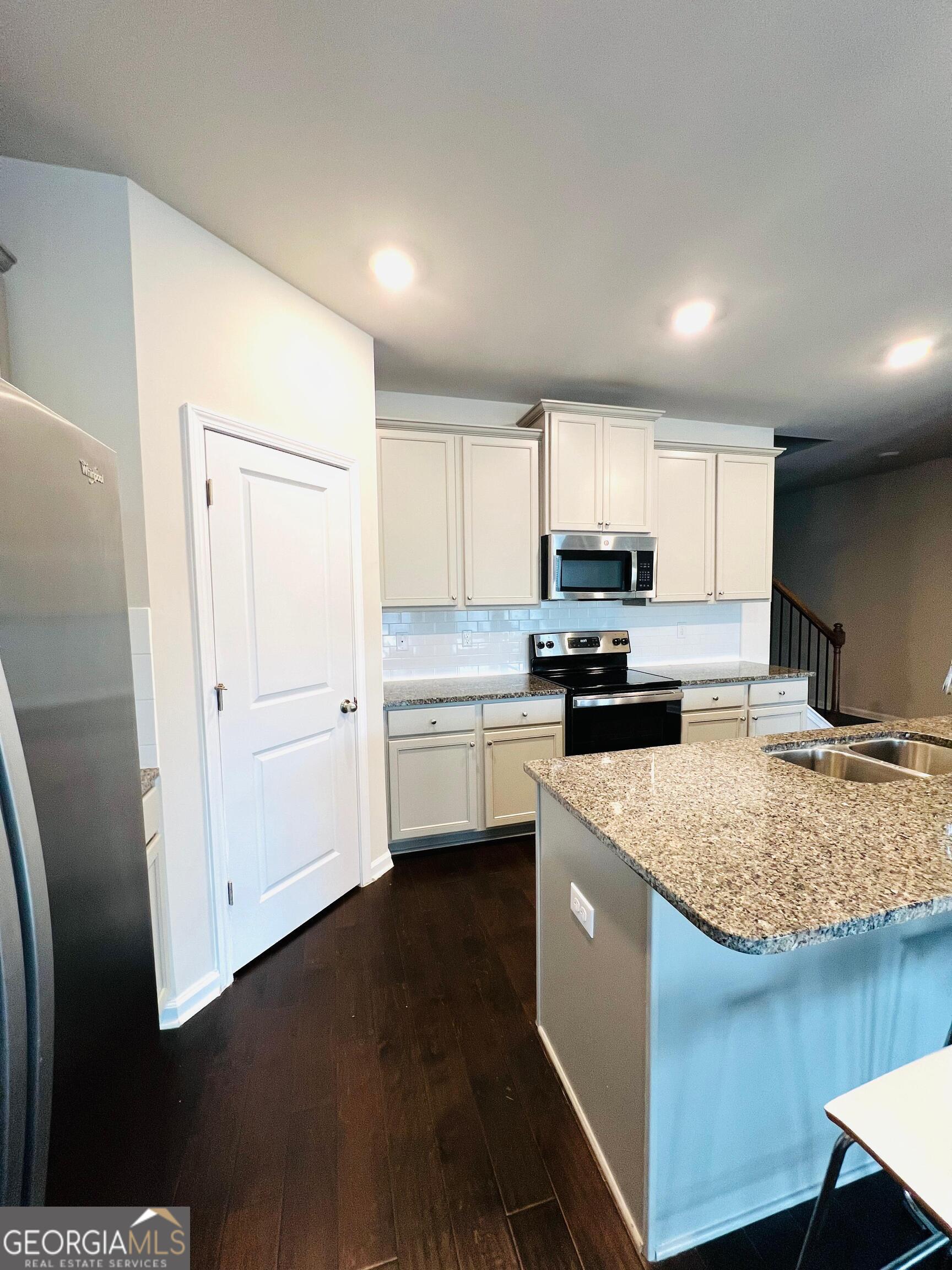 2206 Justify Lane Lithonia, GA 30058 - Photo 6 of 25 a kitchen with a sink a stove a refrigerator and cabinets