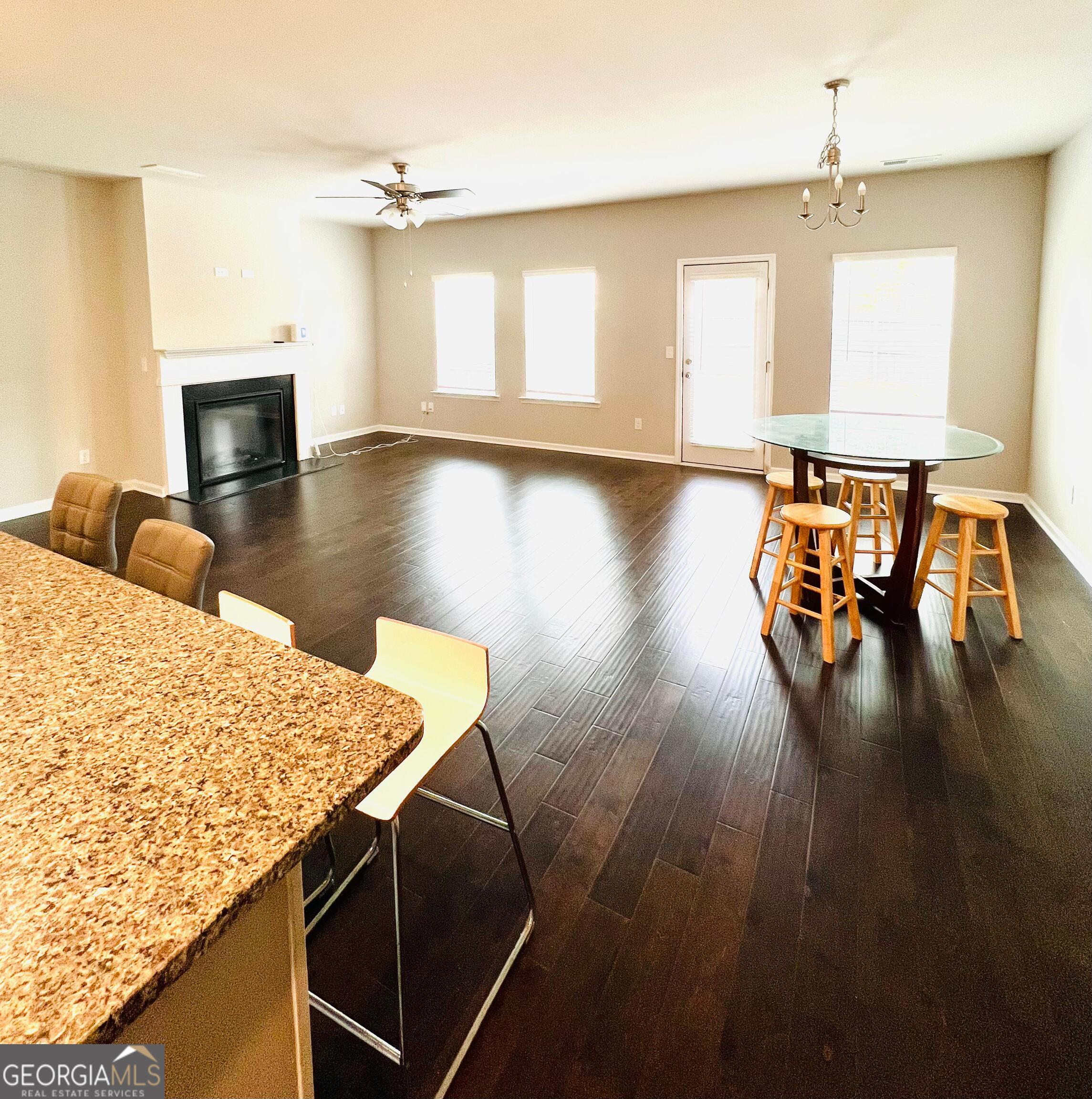 2206 Justify Lane Lithonia, GA 30058 - Photo 7 of 25 a living room with table chairs and a fireplace