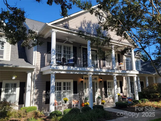 a view of house with yard and green space