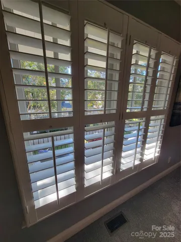 a view of a patio with table and chairs potted plants with wooden floor and fence