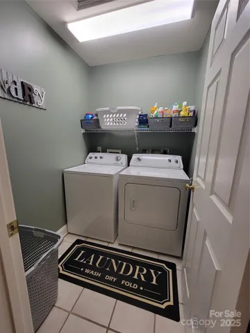 a spacious bathroom with a double vanity sink a toilet a mirror and a window