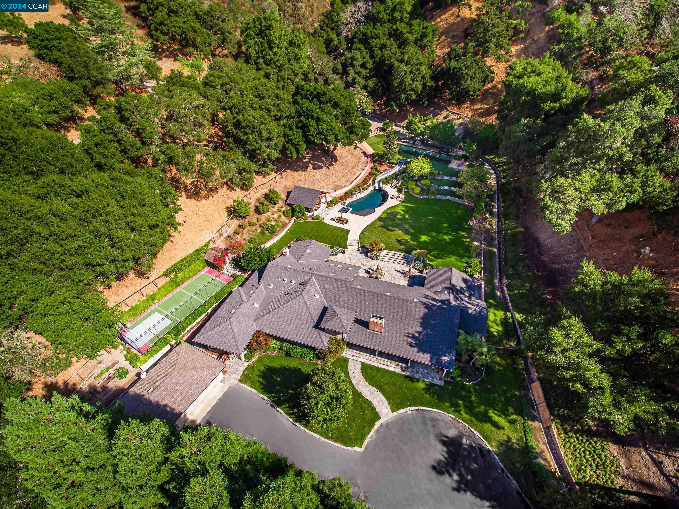 an aerial view of a house with a yard