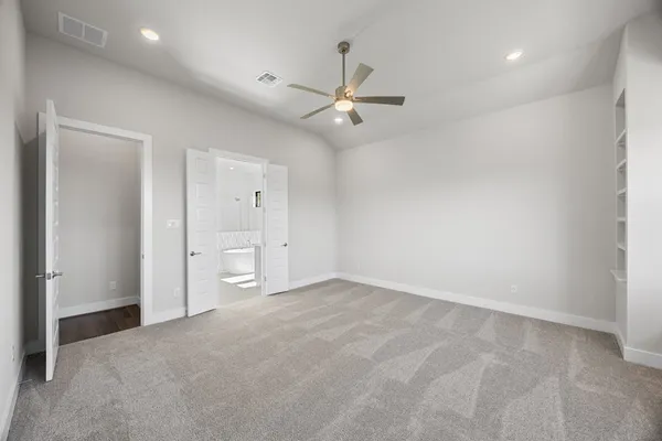 an empty room with a ceiling fan and a window