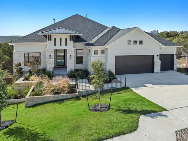 a front view of house with yard and green space