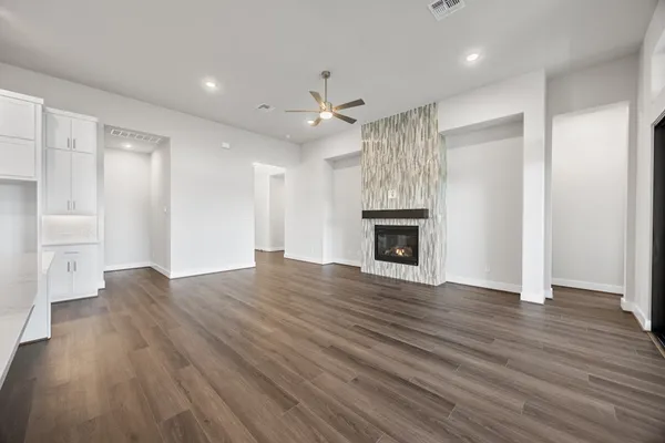a view of empty room with wooden floor and fireplace
