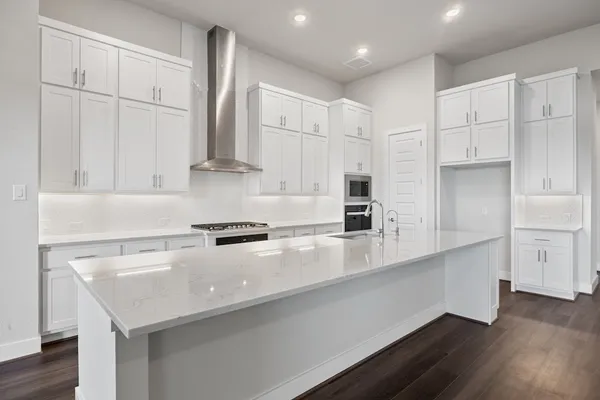 a kitchen with stainless steel appliances a sink stove and cabinets