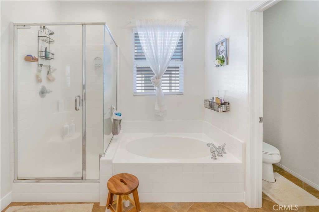 35814 Anderson Street Beaumont, CA 92223 - Photo 30 of 75 a bathroom with a bathtub and a shower