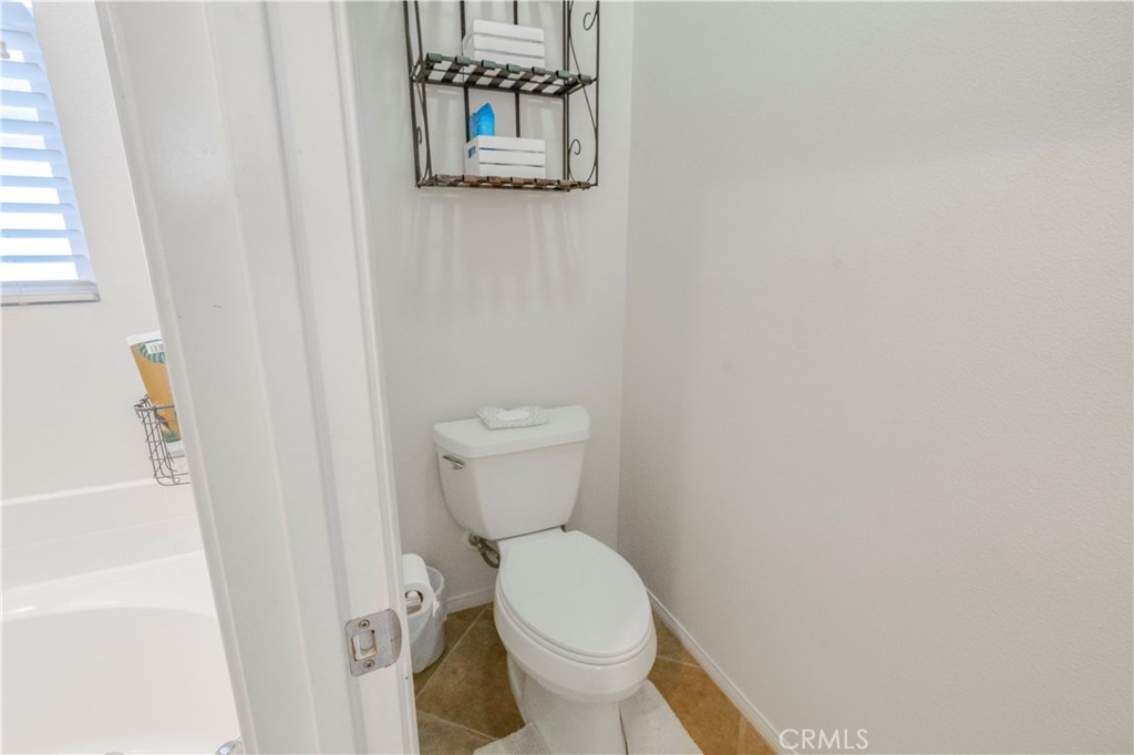 35814 Anderson Street Beaumont, CA 92223 - Photo 31 of 75 a white toilet sitting next to a white cabinet