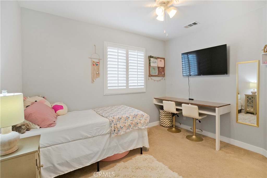 35814 Anderson Street Beaumont, CA 92223 - Photo 40 of 75 a bedroom with a bed and a chandelier