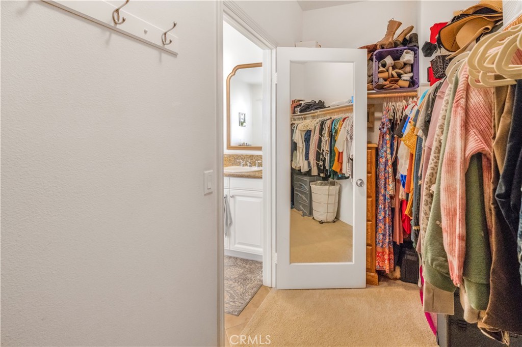 35814 Anderson Street Beaumont, CA 92223 - Photo 48 of 75 a view of walk in closet with clothes